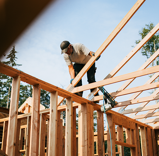 Construction crew framing a new home with construction insurance coverage.
