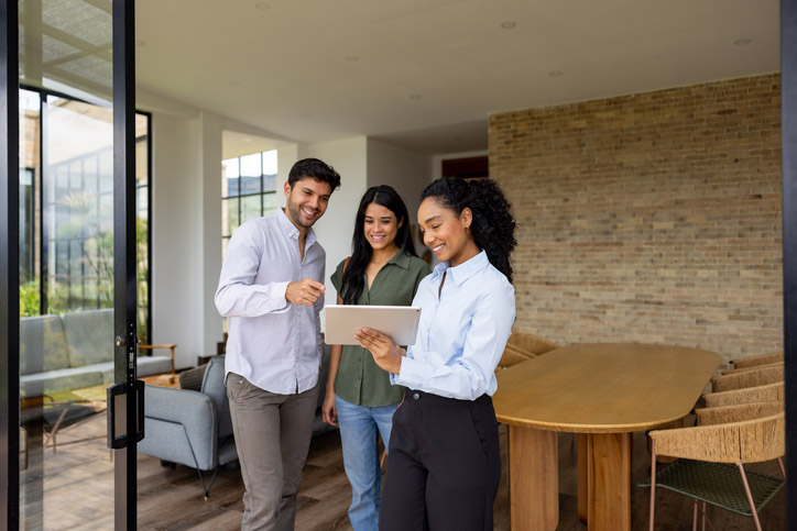 Real Estate Agent Meets with Young Couple